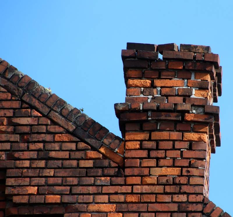Damaged chimney on an Anaheim home showing cracks and missing mortar
